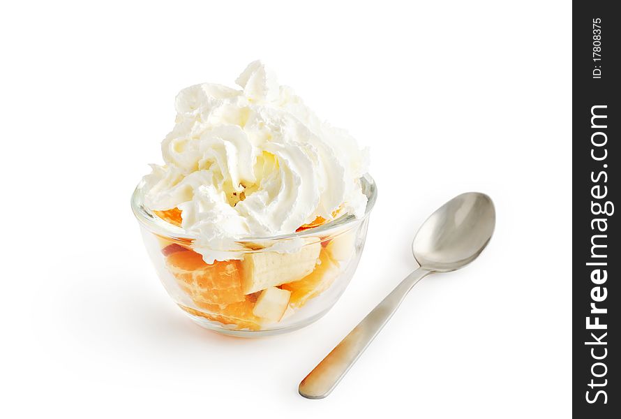 Fruit salad with whipped cream in a glass bowl isolated on white with clipping path. Fruit salad with whipped cream in a glass bowl isolated on white with clipping path