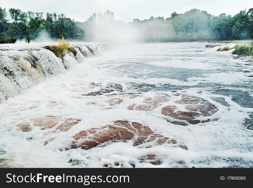 Mist above river, natural waterfall.