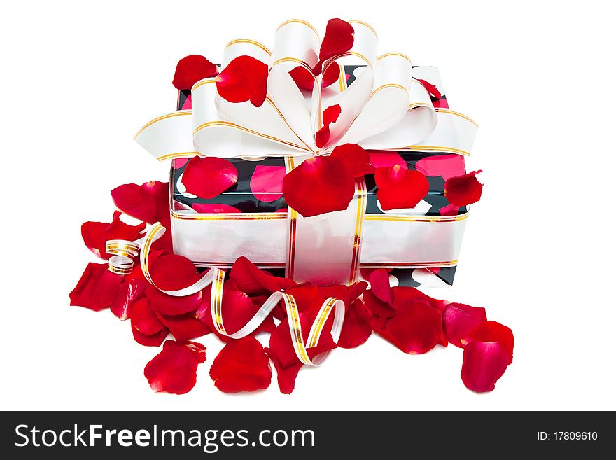 Gift decorated ribbon and rose petals isolated on white