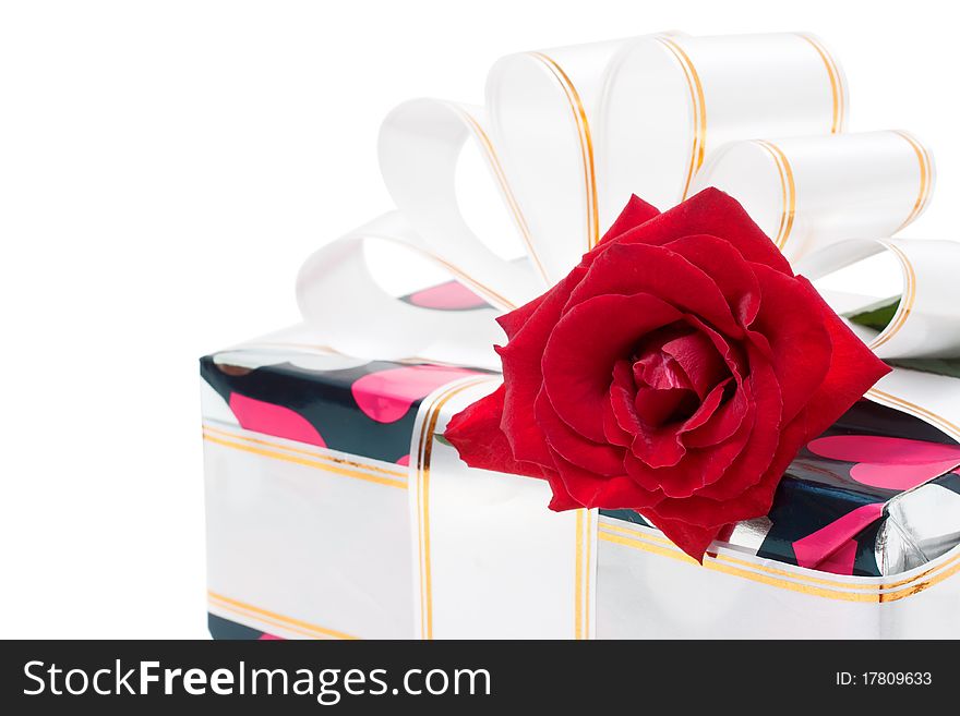 Gift decorated with ribbon and red roses isolated on white