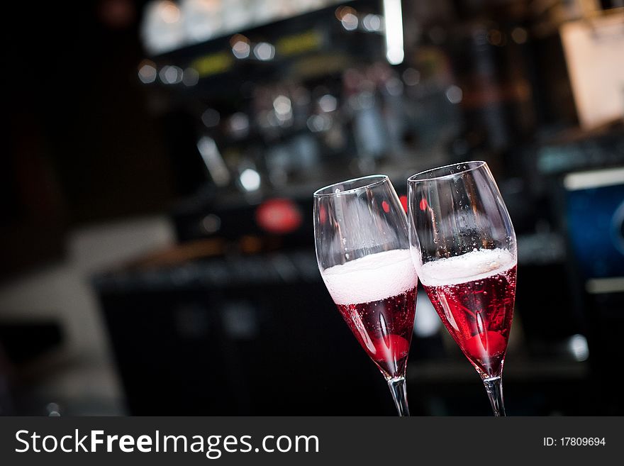 Two glasses of champagne with cherry