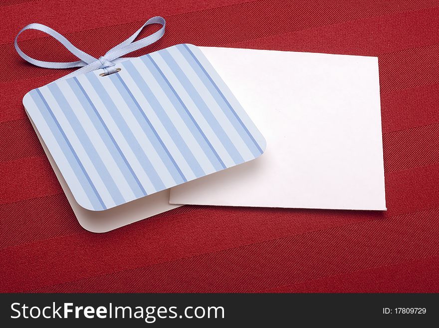 Greeting card with a blue ribbon on a red background.