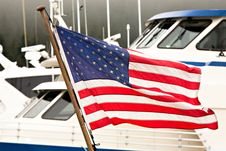 American Flag Flying ALongside Baots In A Harbor Royalty Free Stock Image American Flag Flying ALongside Baots In A Harbor Royalty Free Stock Image