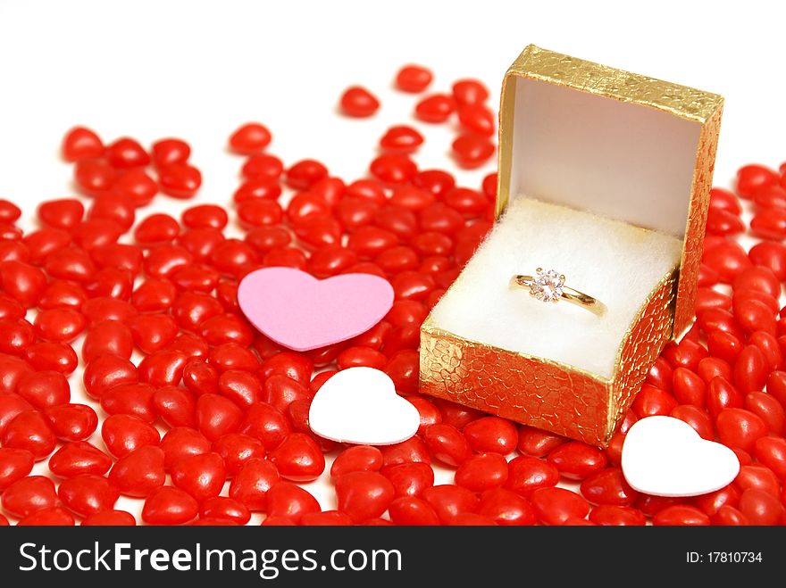 An engagement ring on some heart candy.