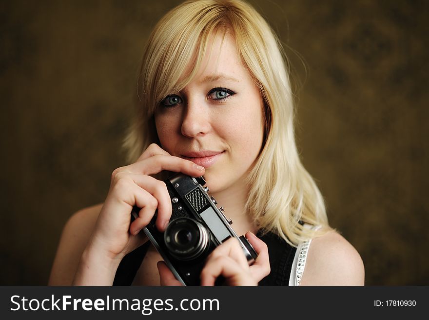 An image of a young woman with a camera. An image of a young woman with a camera