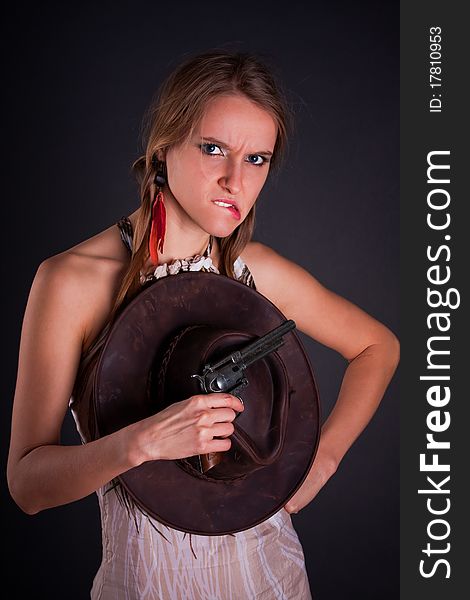 The American Indian girl with a cowboy's hat holds a pistol