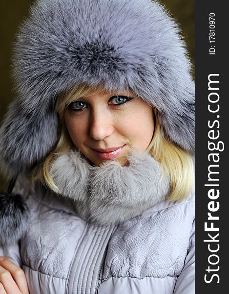An image of a nice woman in grey fur hat