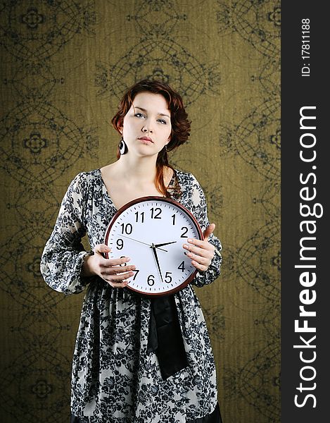 An image of a woman with a big clock. An image of a woman with a big clock