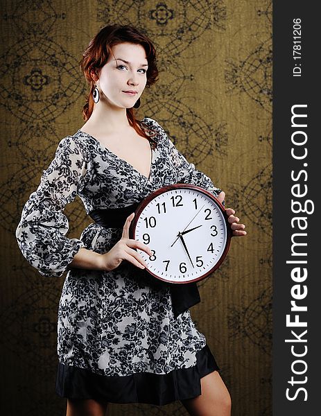 An image of a woman with a big clock. An image of a woman with a big clock