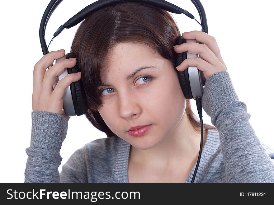 The girl in ear-phones on a white background