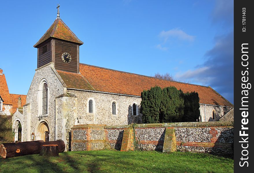 Winter sunshine on a Medieval English Village Church with wooden Clock Tower. Winter sunshine on a Medieval English Village Church with wooden Clock Tower