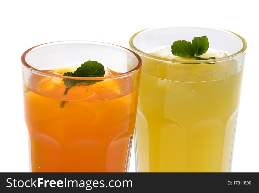 Closeup of two glasses of drinks on a white background. Closeup of two glasses of drinks on a white background