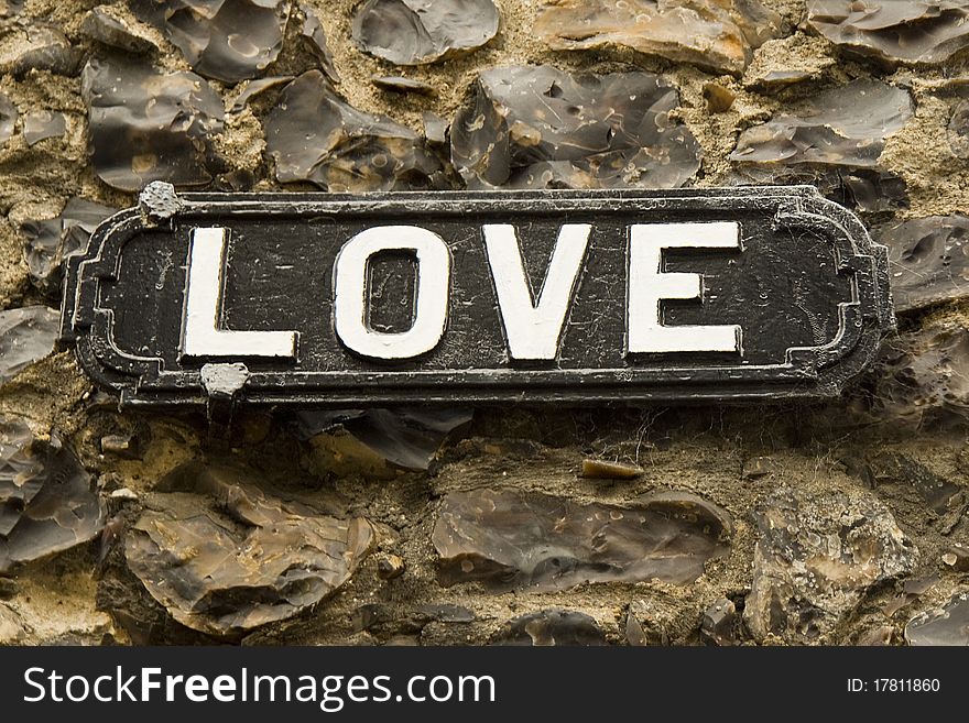 Romantic sign on a flint wall background. Romantic sign on a flint wall background