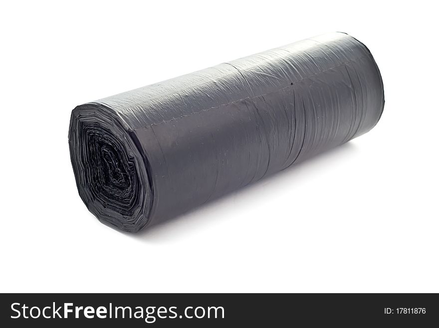 One black rolled garbage bag. Isolated on white with soft shadow