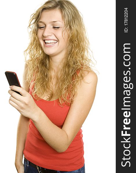 Closeup of an attractive blonde reads text messages from mobile phones and expresses the joy and laughter. Isolated on white background. Closeup of an attractive blonde reads text messages from mobile phones and expresses the joy and laughter. Isolated on white background
