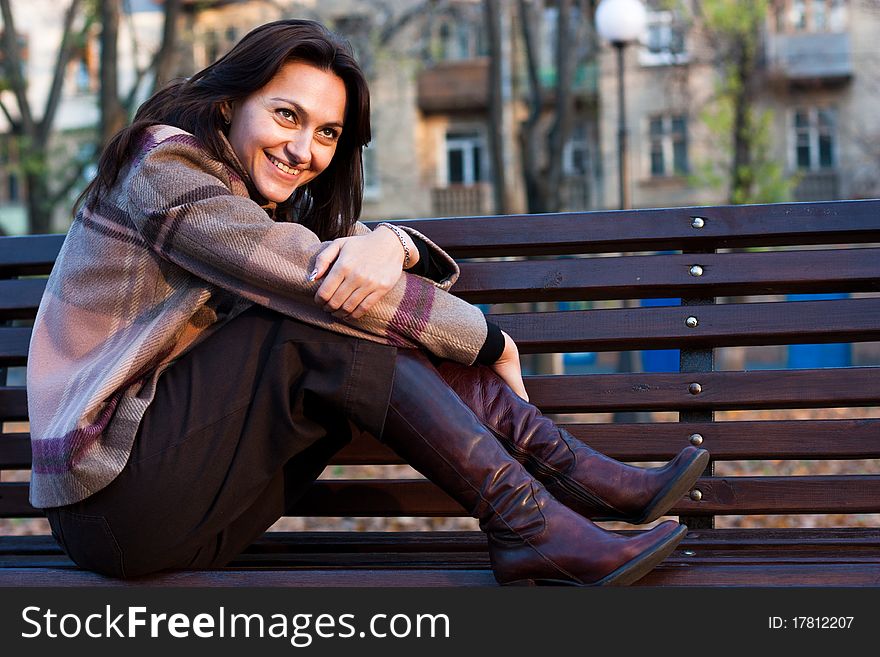 Beautiful young woman on a bench in autumn. Beautiful young woman on a bench in autumn