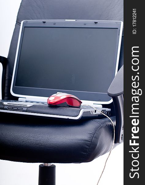 Business chair with laptop, glasses and mouse