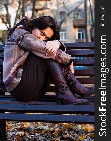 Beautiful young woman on a bench in autumn. Beautiful young woman on a bench in autumn