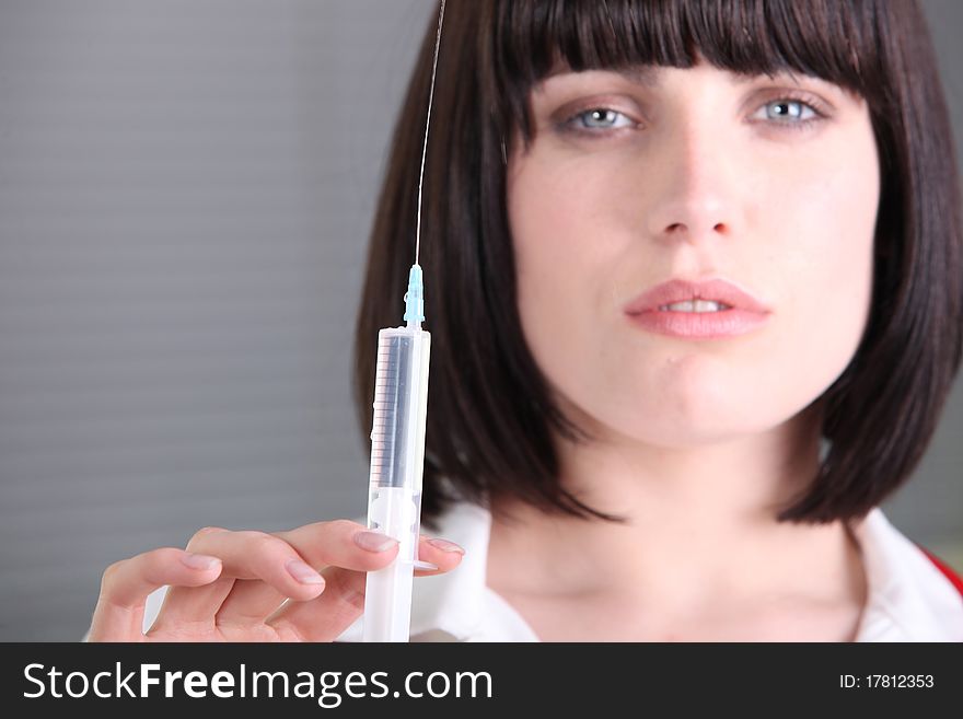 Young woman whit a syringe