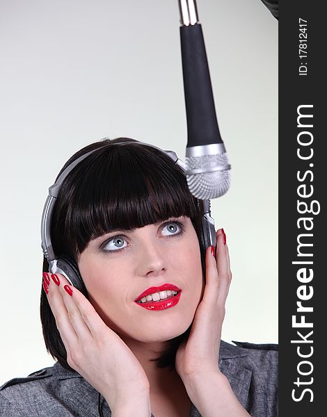 Young Woman Singer On Gray Background