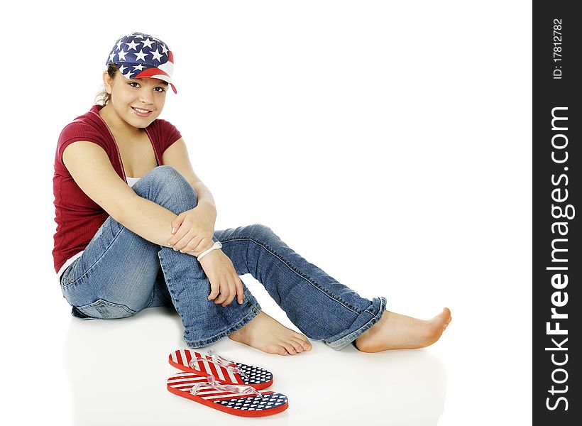 Portrait of a beautiful young American teen wearing stars and stripes on her hat and flip-flops,. Portrait of a beautiful young American teen wearing stars and stripes on her hat and flip-flops,