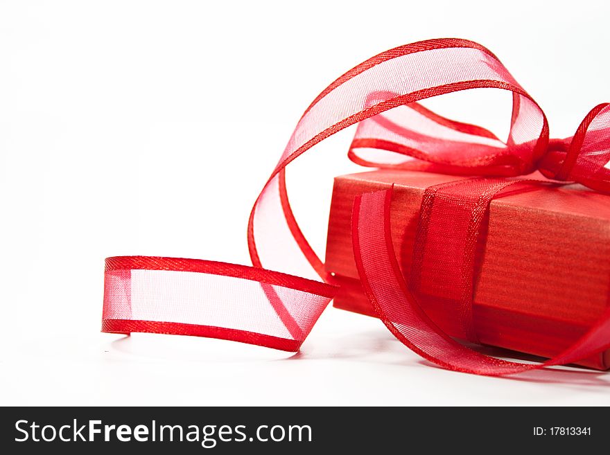 Red gift with red ribbon isolated on white background