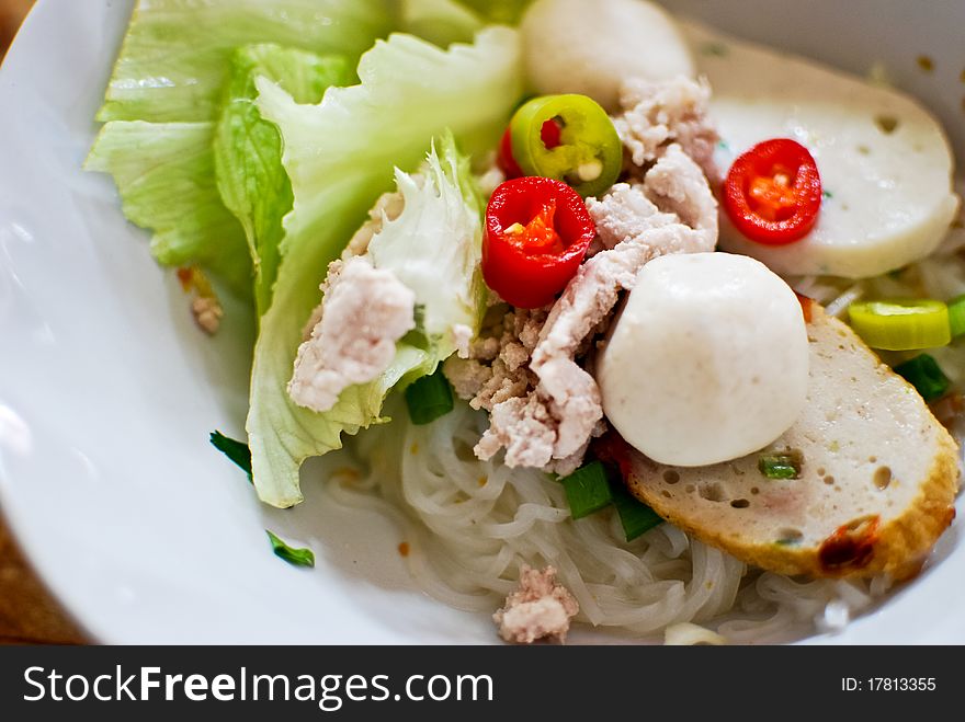 Asian style noodle with pork , fish ball and vegetables