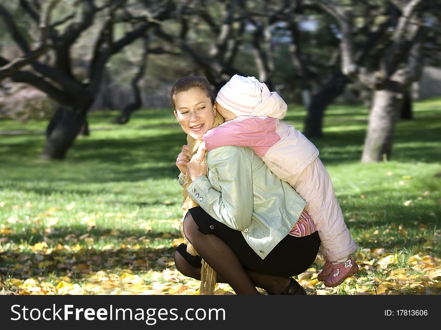 mother and daughter playing outdoors. mother and daughter playing outdoors