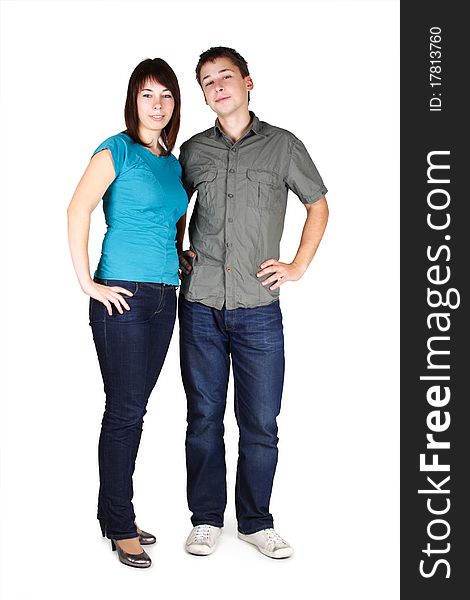 Young brunette man and girl in jeans standing and looking at camera, isolated