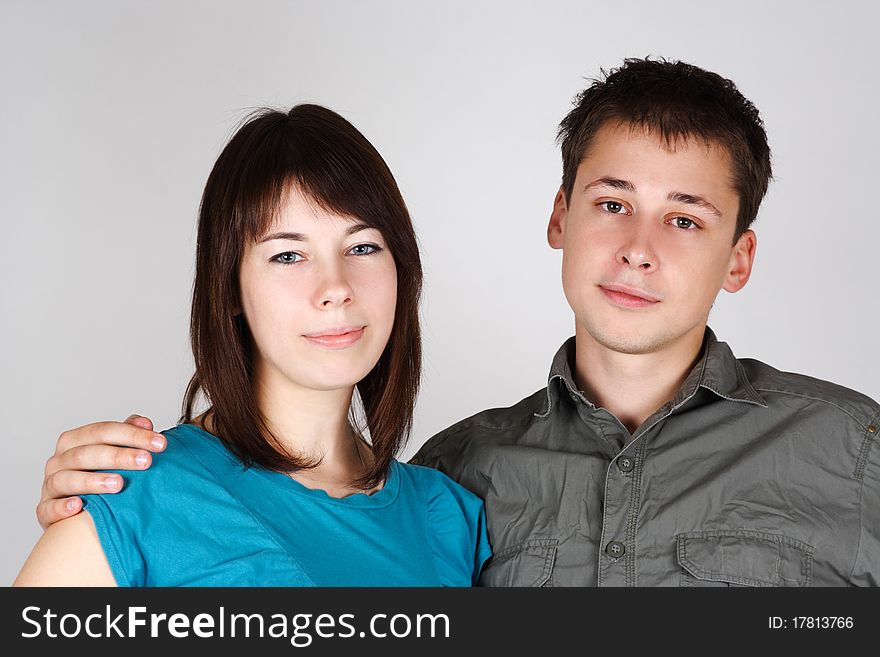 Portrait of man embracing brunette girl and looking at camera. Portrait of man embracing brunette girl and looking at camera