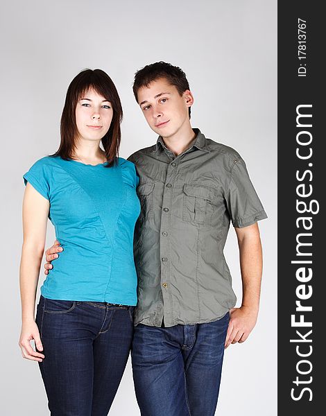 Portrait of man embracing brunette girl and looking at camera. Portrait of man embracing brunette girl and looking at camera