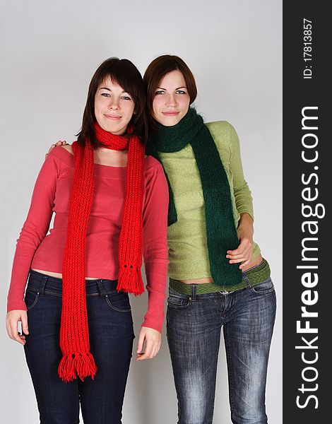 Portrait of two young girls in green and red scarfs