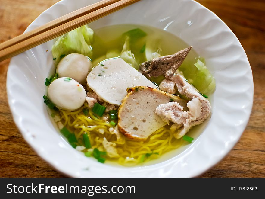 Asian style noodle with pork , fish ball and vegetables