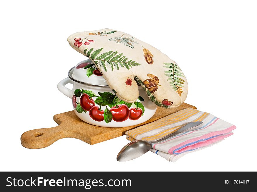 A metal pan and kitchen utensils on a cutting board.