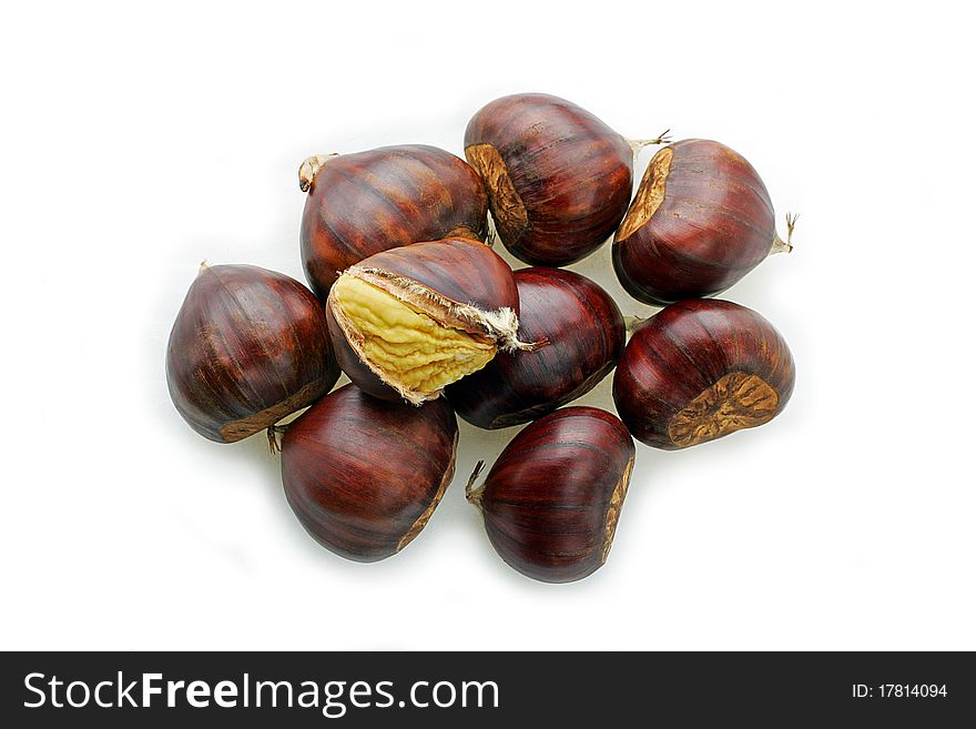 Nine chestnuts one with the husk open to show the nut. Nine chestnuts one with the husk open to show the nut