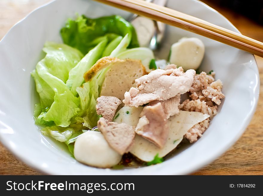 Asian style noodle with pork , fish ball and vegetables