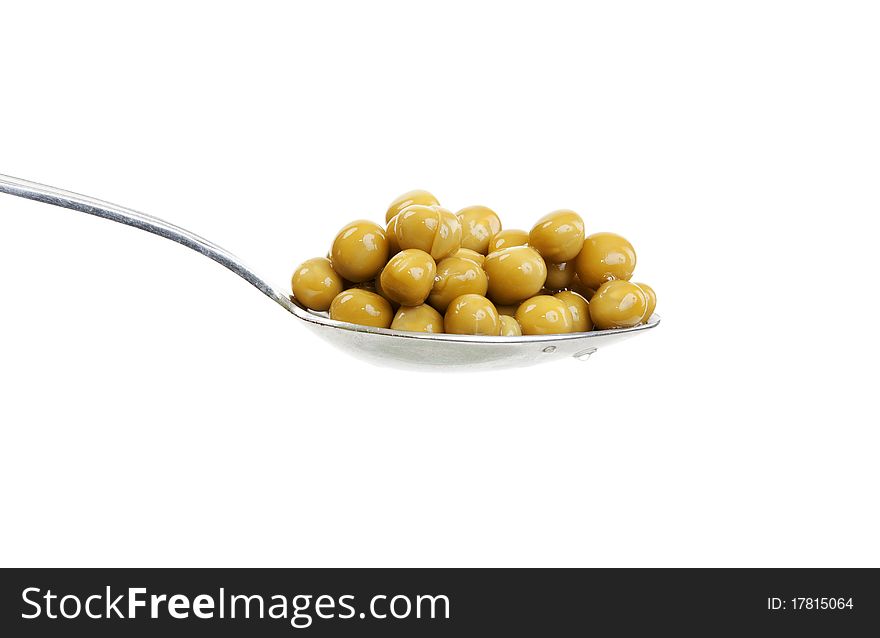 Spoon with green peas on a white background