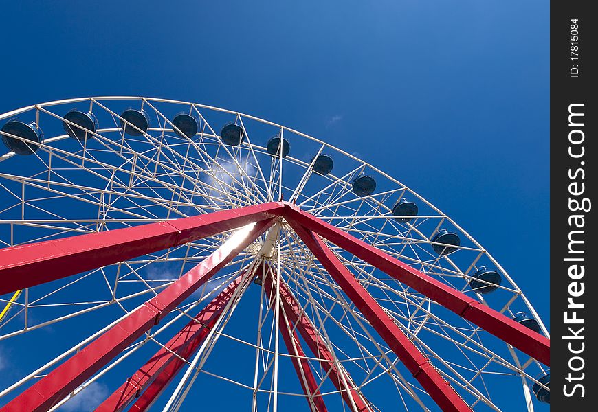 White ferris wheel with blue sky in the background. White ferris wheel with blue sky in the background