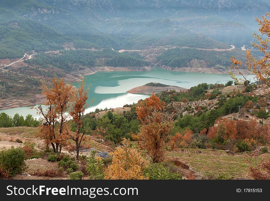 Views of the azure mountain lake through the pine forest. Views of the azure mountain lake through the pine forest