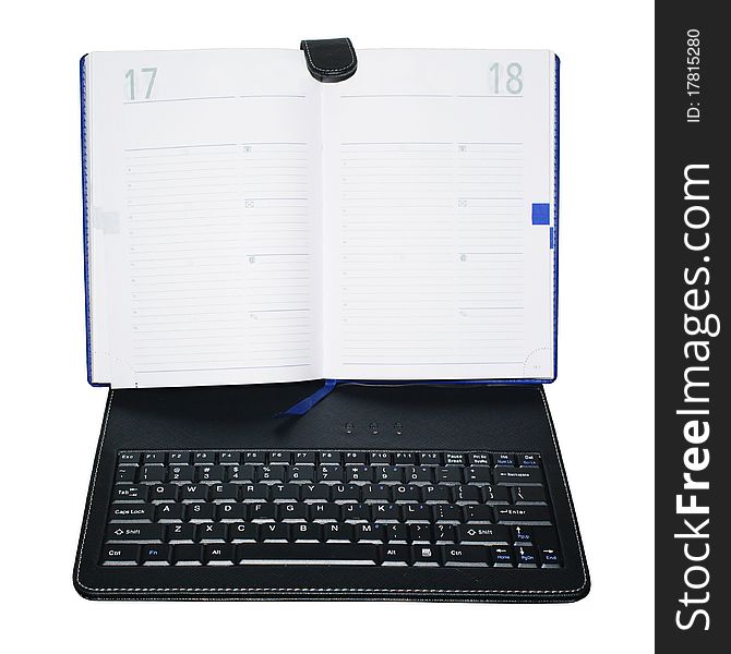 An unusual device that combines a paper notebook and laptop keyboard. Isolation.