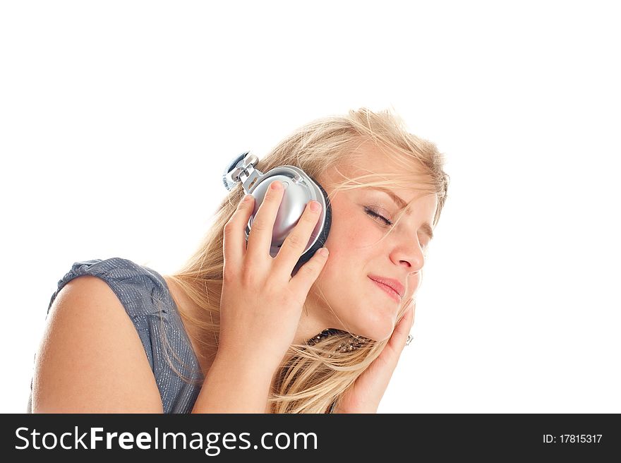Young lady listening to music on headphones against white background