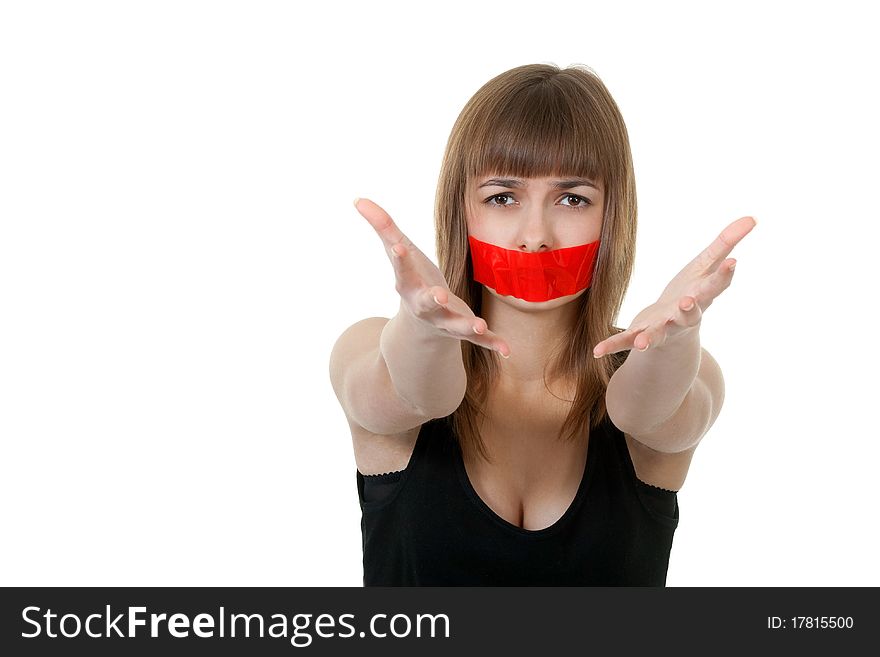Beautiful girl with her mouth sealed with red tape