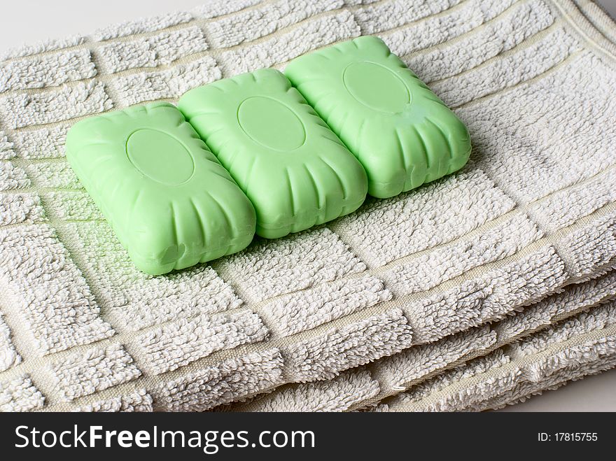 Three pieces of soap lying on towel. Three pieces of soap lying on towel.