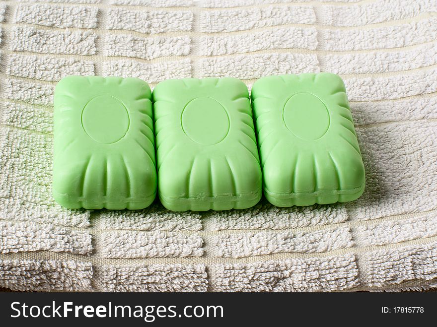 Three pieces of soap lying on towel. Three pieces of soap lying on towel.