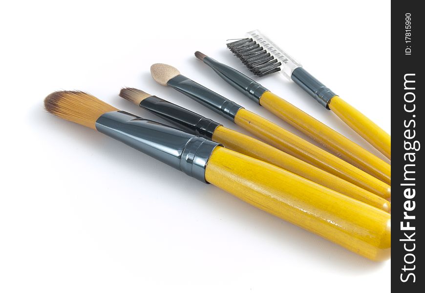 Cosmetics brushes on white background