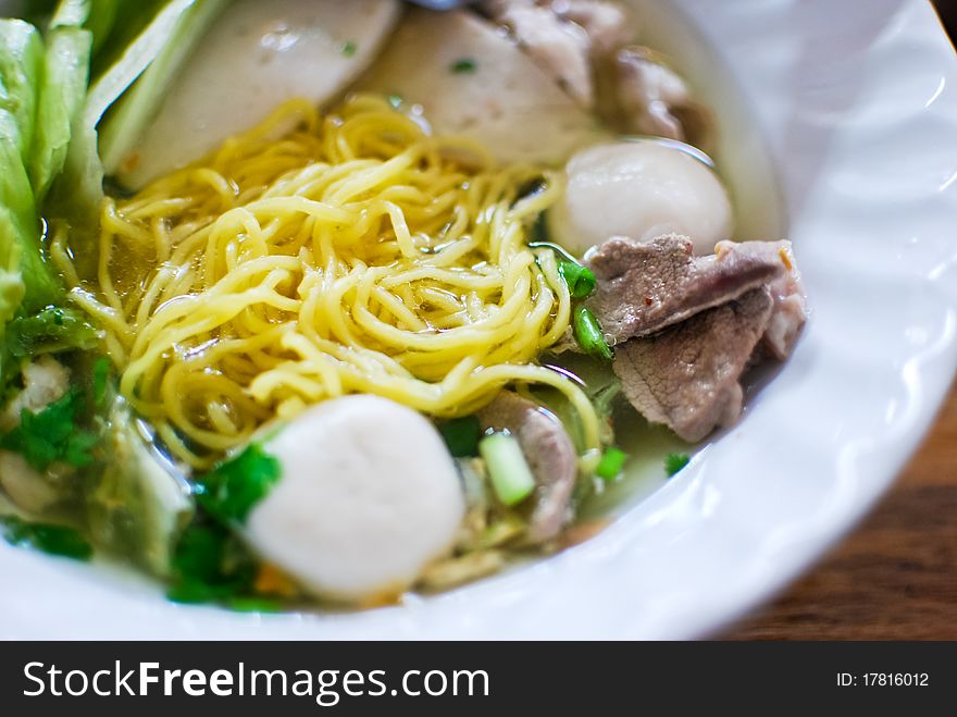 Asian style noodle with pork , fish ball and vegetables