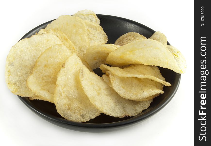 Crispy chips on a black saucer