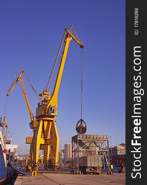 Giant cranes unloading a cargo ship in the Mediterranean Sea. Giant cranes unloading a cargo ship in the Mediterranean Sea