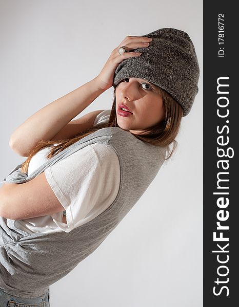 A cute picture of a young model posing in a gray hat, gray vest, and white shirt. A cute picture of a young model posing in a gray hat, gray vest, and white shirt.