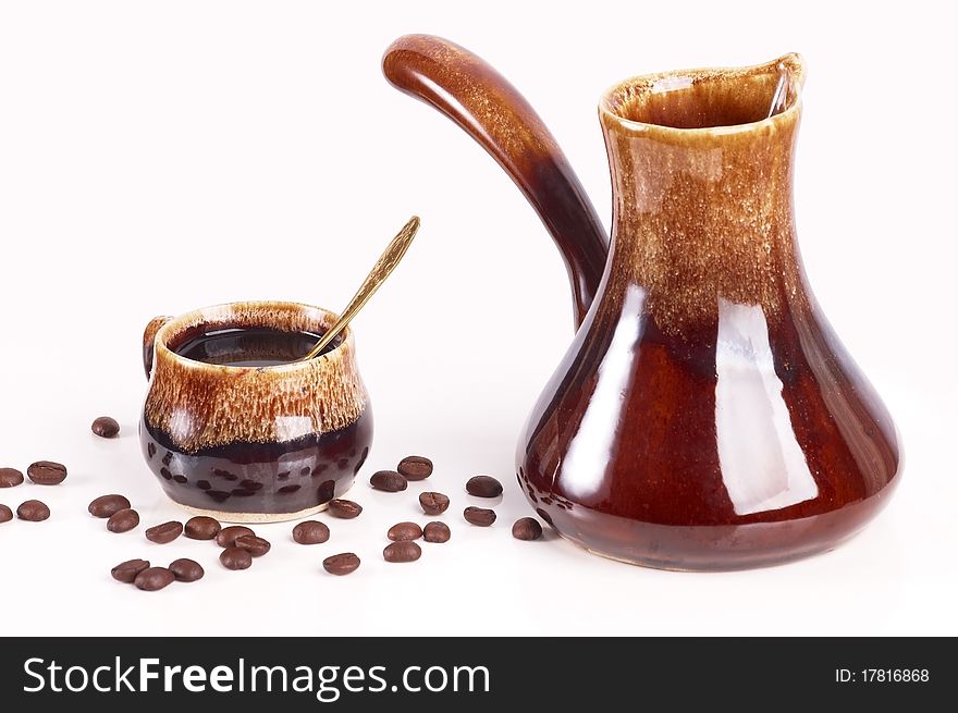 Cup Of Coffee With A Coffee Pot